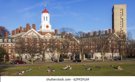 CAMBRIDGE, USA - APRIL 20: View Of The Architecture Of Cambridge In Massachusetts, USA By The Harvard University With Lots Of Student Enjoying A Sunbath By The Charles River On April 20, 2010.