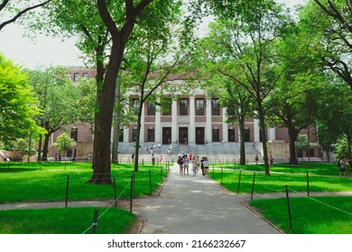 CAMBRIDGE, USA - JULY 14: View of the campus of the famous Harvard University in Cambridge, Massachusetts, USA with some students, locals, and tourists passing by on July 14, 2019.