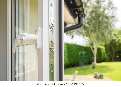 Cambridgeshire, UK - Circa July 2019: Brand New Isntalled Double Glazing Windows Seen In A House Annex. Detail Of The Multiple Window Locks Can Rubber Window Sealing Is Visible, Adjacent To A Garden.