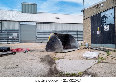 Cambridgeshire, UK - Circa July 2022: Large Digger Bucket Seen Abandoned
In A Milling Facility. The Bucket Is Used To Help Scoop The Non Refined Grains For The Mill At The Background.