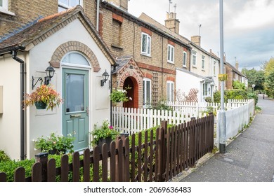 Cambridgeshire, UK - Circa November 2021: Row of terraced cottages seen in an East Anglian town. Located down a very narrow one way street opposite an inland water way.