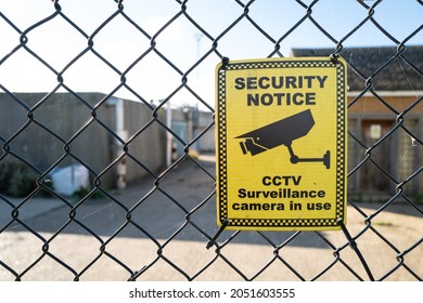 Cambridgeshire, UK - Circa October 2021: CCTV security sign seen attached to a metal fence, at the entrance to an industrial treatment plant. Due to the rise in rural crime, CCTV has been installed.