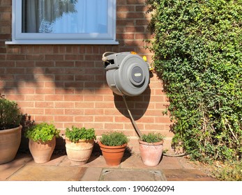 Cambridge,UK July 2020; Wall Mounted Hozelock Retractable Garden Hose Pipe