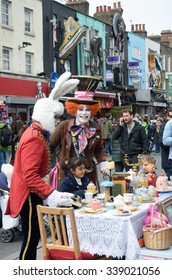 CAMDEN HIGH STREET LONDON  ENGLAND  5 May  2015:  Mad Hatters Tea Party On Street With Men In Costume