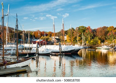 Camden, Maine Harbor With Bright Fall Foliage In Autumn. Boats Are Being Covered In Anticipation For Winter.