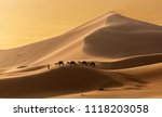 A camel caravan moves in the Sahara Desert during a desert storm, Morocco