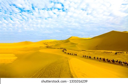 Camel caravan in sand desert landscape. Camel caravans in desert scene. Sand desert camel caravan panorama. Camel caravan in desert