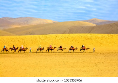 Camel Caravan In Sand Dune Desert Landscape