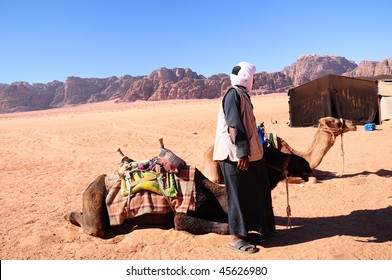 camels and bedouin on desert