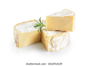 Camembert cheese and rosemary isolated on white background.
