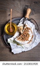 Camembert Soft Cheese Is Served On An Iron Dish With Walnuts, Honey And Thyme. View From Above