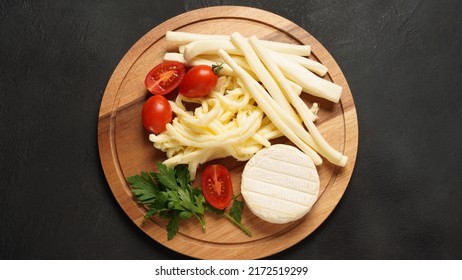 Camembert With String Cheese Or Cheese Whip - Salty Snack Cheese With Cherry Tomatoes And Herbs On Chopping Board. 