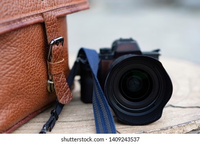 camera and bag on stone table
