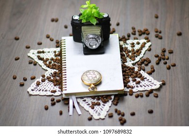 camera, coffee, watch and notebook.