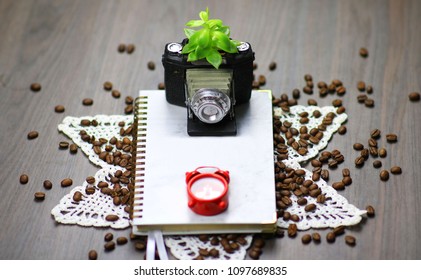 camera, coffee, watch and notebook.