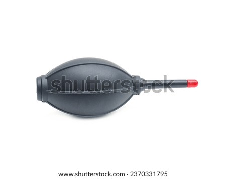 Camera and computer lens cleaning equipment, black air blower with red tip for blowing dust.  Placed isolated on a white background.