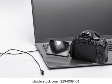 Camera - a digital SLR camera with an open screen standing on a laptop