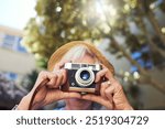 Camera, explore and senior woman in nature for memory, social media or online blog for travel. Retro, photography and elderly female person in retirement with dslr equipment outdoor on vacation.