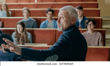 Camera Facing Class: College Professor Gives a Lecture to a Classroom Full of Multi Ethnic Students. Talented Speaker Captures Audience Attention.