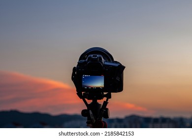 a camera filming the sunset