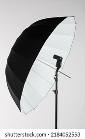 Camera Flash Head Mounted On Stand With Umbrella Light Reflector In Photography Studio