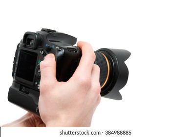 Camera in hand. Close-up of hand holding camera while isolated on white