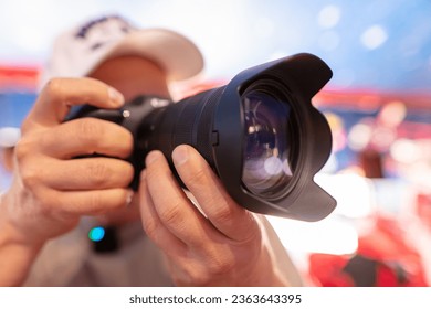 Camera in the hands of a male photographer. Close-up.