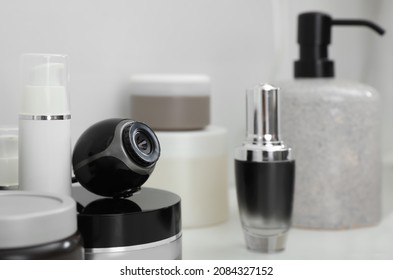 Camera Hidden Among Different Toiletries On Table In Bathroom