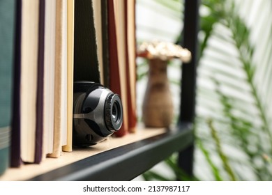 Camera Hidden Between Books On Wooden Shelf Indoors, Closeup. Space For Text