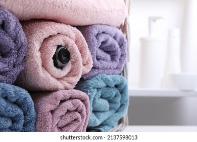 Camera Hidden Between Towels In Bathroom. Space For Text