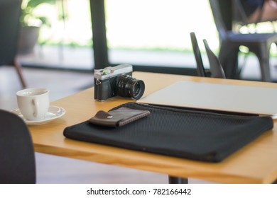 Camera and laptop on the table.