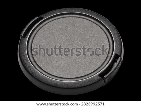 Camera lens cap, isolated on black background