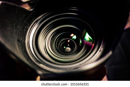 Camera lens closeup with light reflection and blurred background