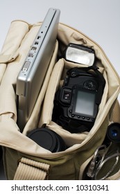 The Camera, Lens, Flash And Laptop In A Bag