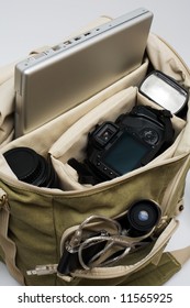 The Camera, Lens, Flash And Laptop In A Bag