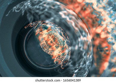 Camera lens with light reflected in it, soft focus. Photographic lens. Camera aperture.