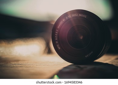 camera lens on the table and in the background sunlight