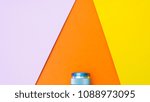 Camera lens with Paper shape triangle background.Pink,orange and yellow colors.