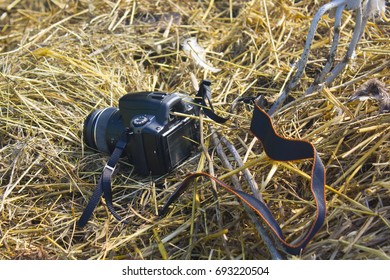 the camera is lying on a haystack