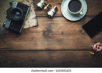 camera with map and coffee on the table