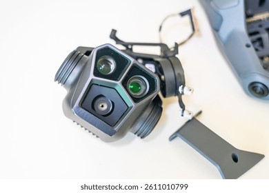 Camera module for drone featuring dual lenses and infrared sensors on white background