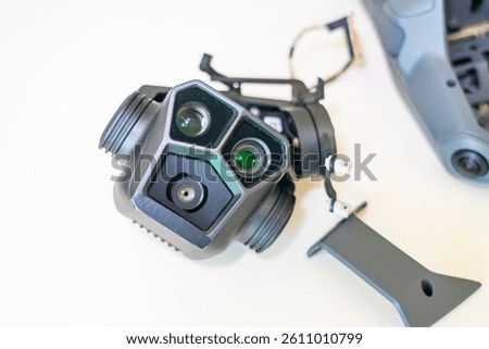 Camera module for drone featuring dual lenses and infrared sensors on white background