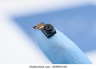 Camera Module On Fingertip. Smartphone Cell Phone Small Camera Sensor With High Resolution, Research Or Repair Concept. 