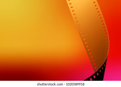 Camera Negative Film. Selective Focus On Film Perforation. Unprocessed Color Motion Picture Film. Industry Symbol For Shooting Process, Photochemical Laboratory Process And Film Archive Technology. 