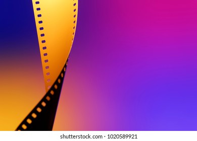 Camera Negative Film. Selective Focus On Film Perforation. Unprocessed Color Motion Picture Film. Industry Symbol For Shooting Process, Photochemical Laboratory Process And Film Archive Technology. 