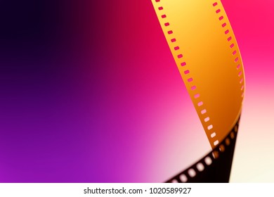 Camera Negative Film. Selective Focus On Film Perforation. Unprocessed Color Motion Picture Film. Industry Symbol For Shooting Process, Photochemical Laboratory Process And Film Archive Technology. 