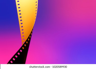 Camera Negative Film. Selective Focus On Film Perforation. Unprocessed Color Motion Picture Film. Industry Symbol For Shooting Process, Photochemical Laboratory Process And Film Archive Technology. 