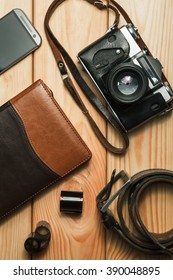 Camera, notebook and mobile phone on a wooden background. Still life. top view