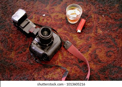 Camera On The Dirty Carpet In A Seedy Motel Room With Alcohol And Cigarette Lighter - After Show Party 