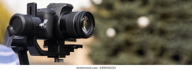The camera is on a stabilizer for video shooting - Shutterstock ID 2300102333